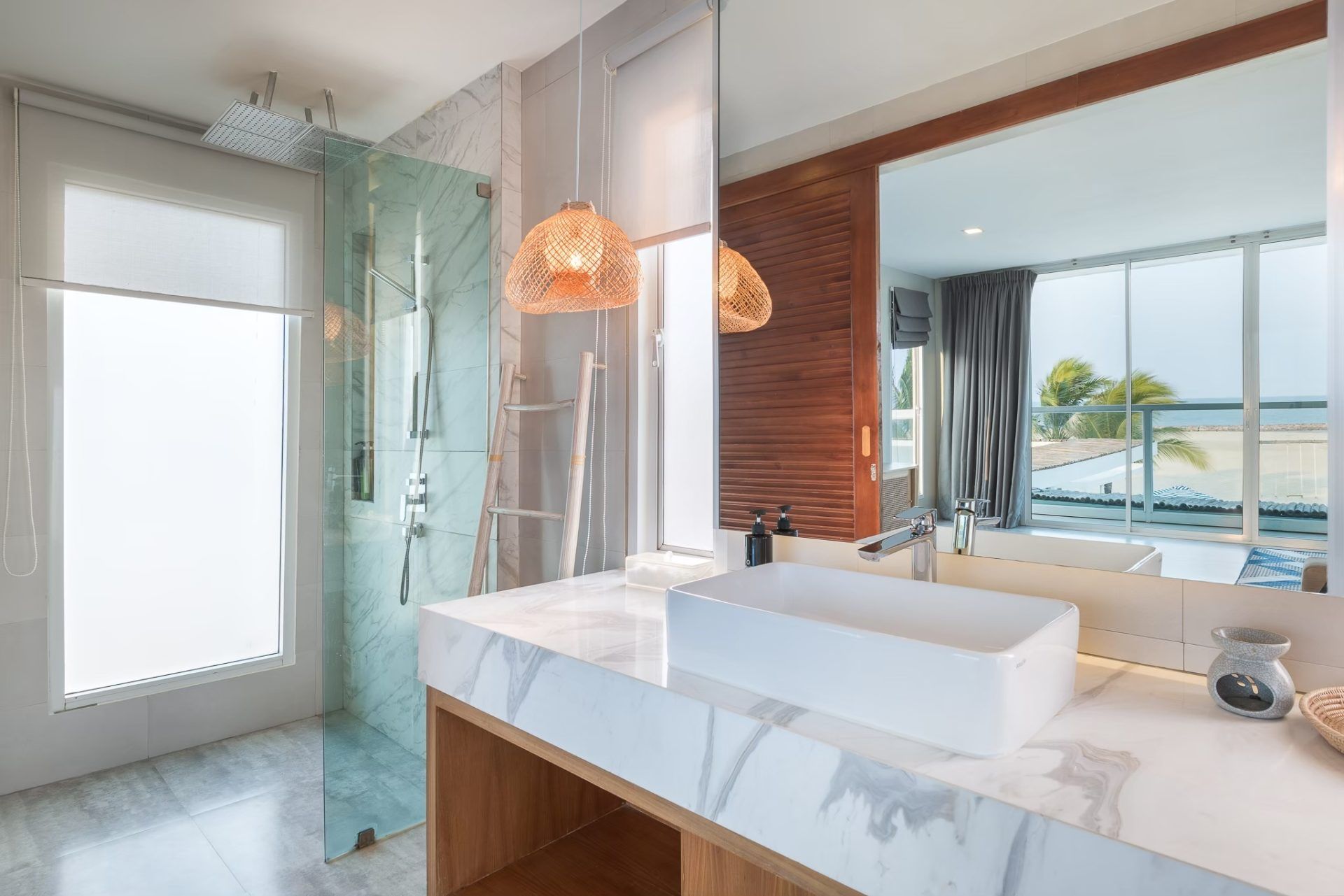 Vela VI Pool Villa bathroom vanity with marble countertop and ocean view, หาดปึกเตียน ชะอำ.