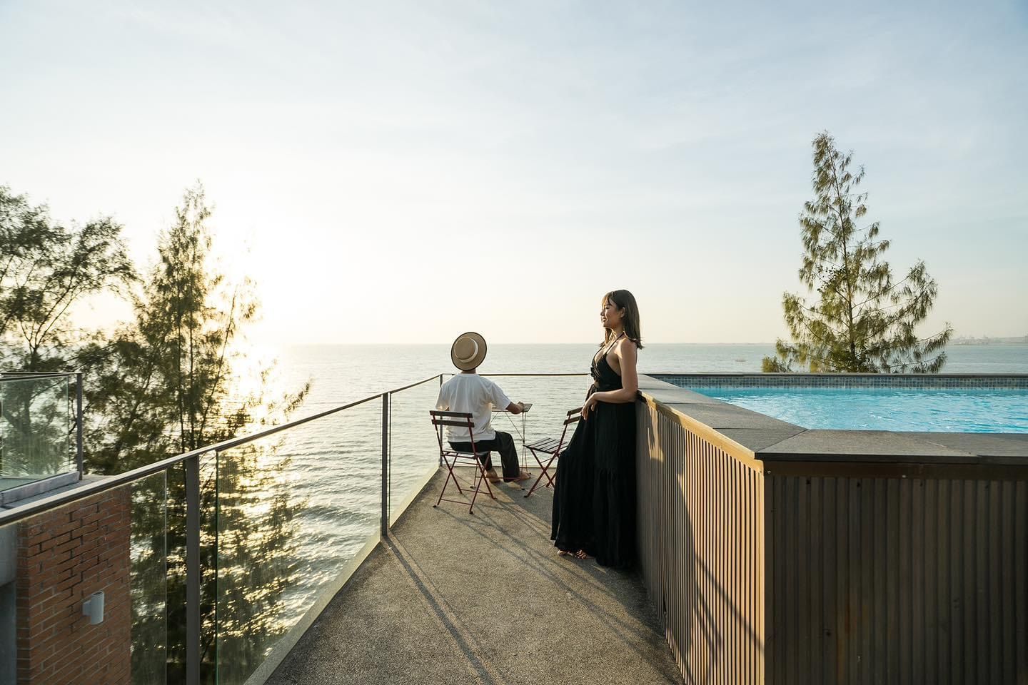 Ocean view terrace with pool at Pink Sand Beachfront Villa, บางละมุง พัทยาเหนือ. Couple relaxing by the pool.