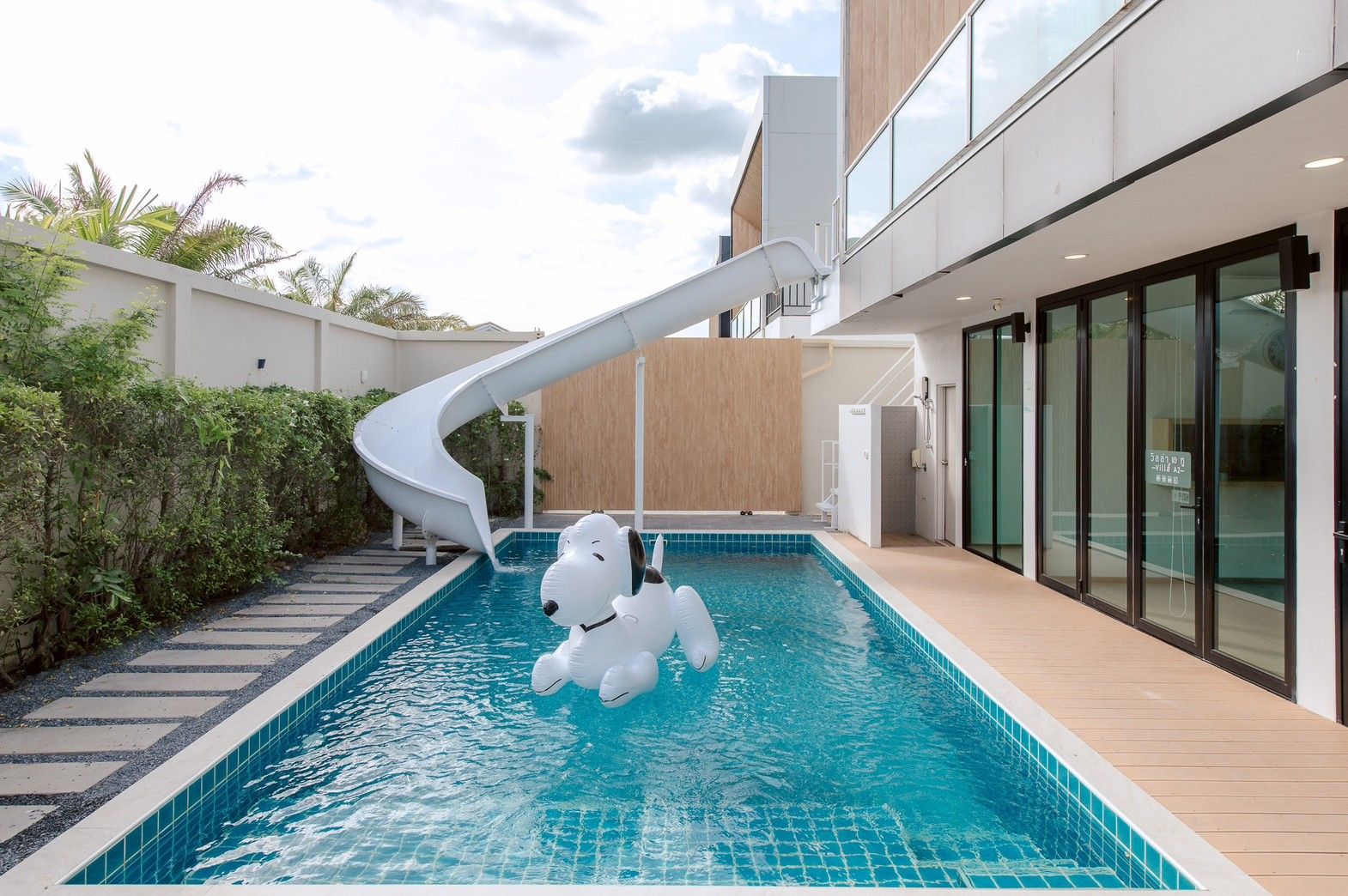 Private pool with waterslide and Snoopy float at Pool Lay AII Pool Villa, Na Jomtien, Pattaya, Thailand.