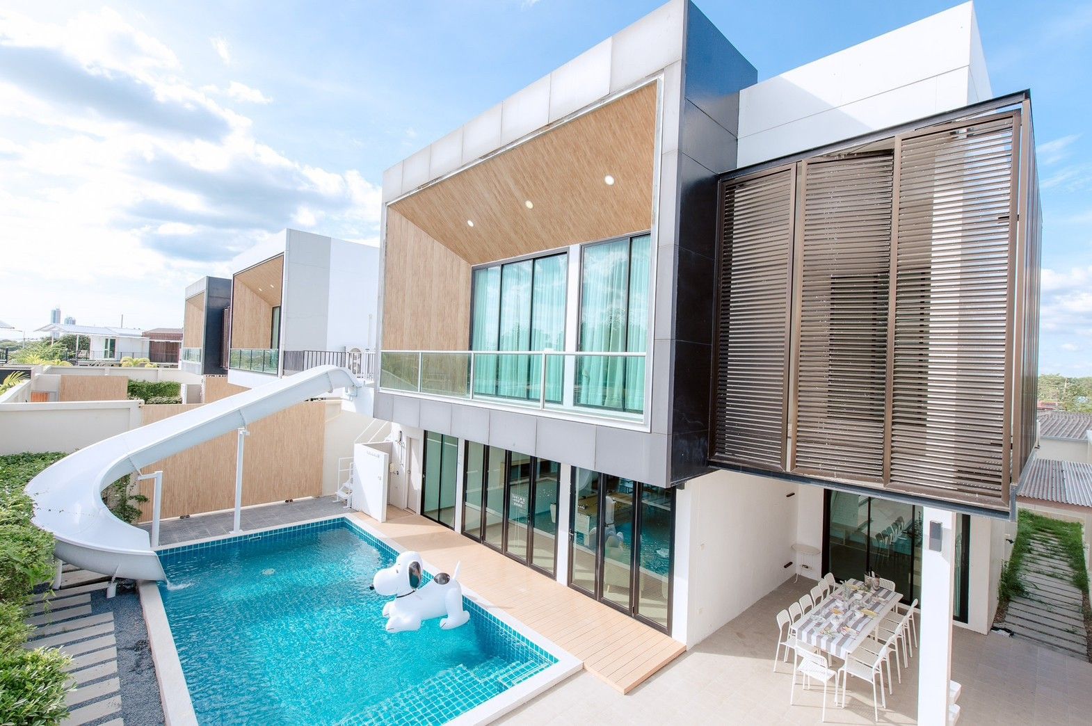 Pool Lay AII Pool Villa in Na Jomtien, Pattaya, features a private pool with a waterslide and dog float.