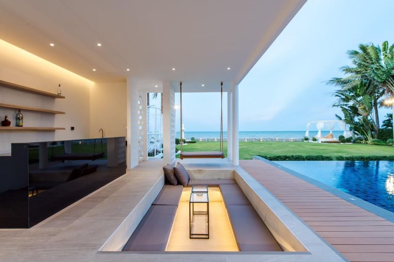 Outdoor lounge with swing at Private Heaven VI Pool Villa, Cha-Am. Sunken seating area overlooks the pool and ocean view.