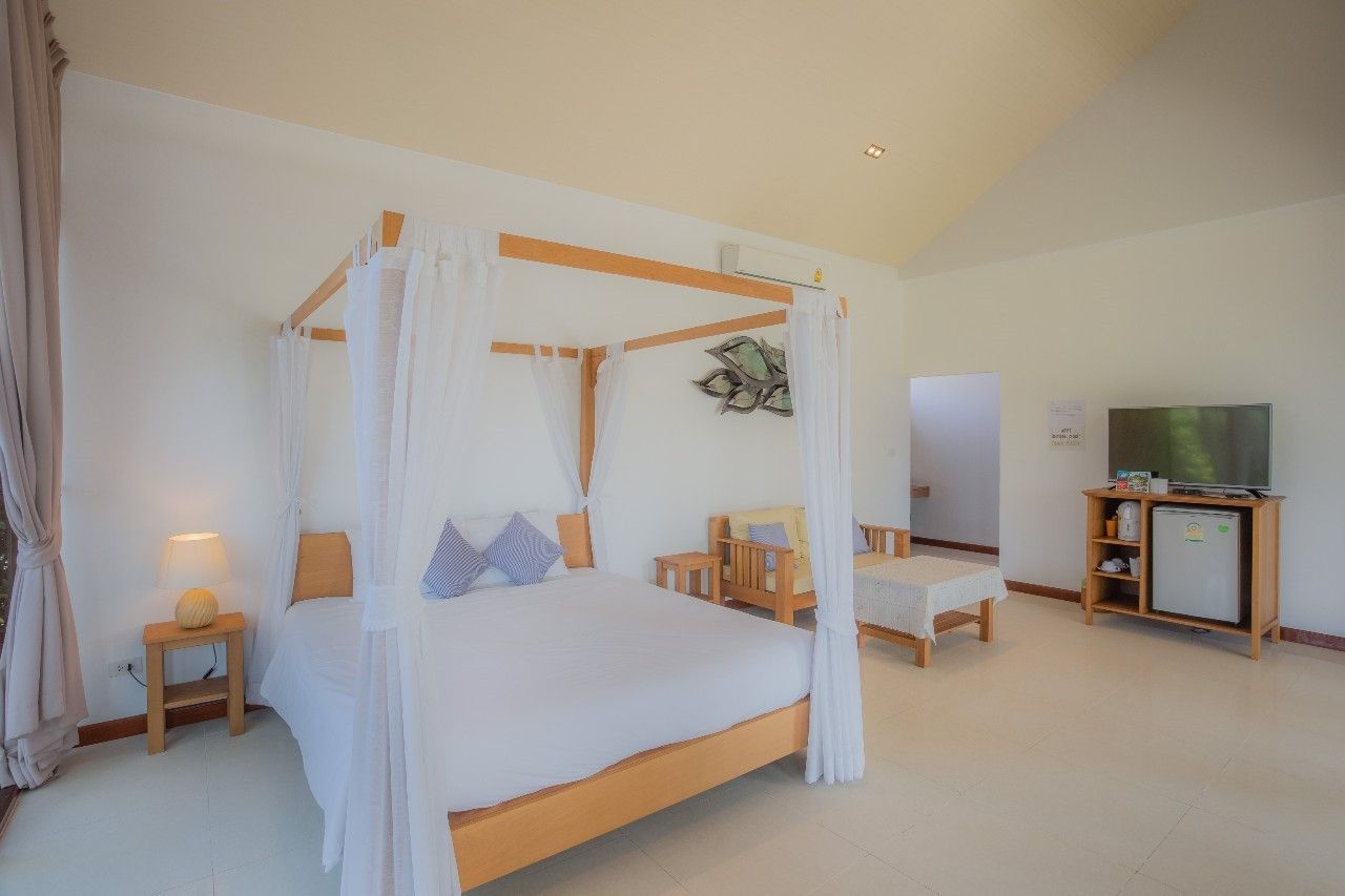 Bright bedroom with four-poster bed at Proud I Pool Villa, Hua Hin, Thailand