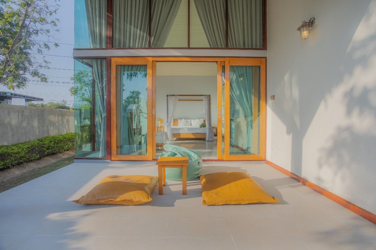 Patio with beanbag chairs outside bedroom at Proud II Pool Villa, Hua Hin, Thailand.