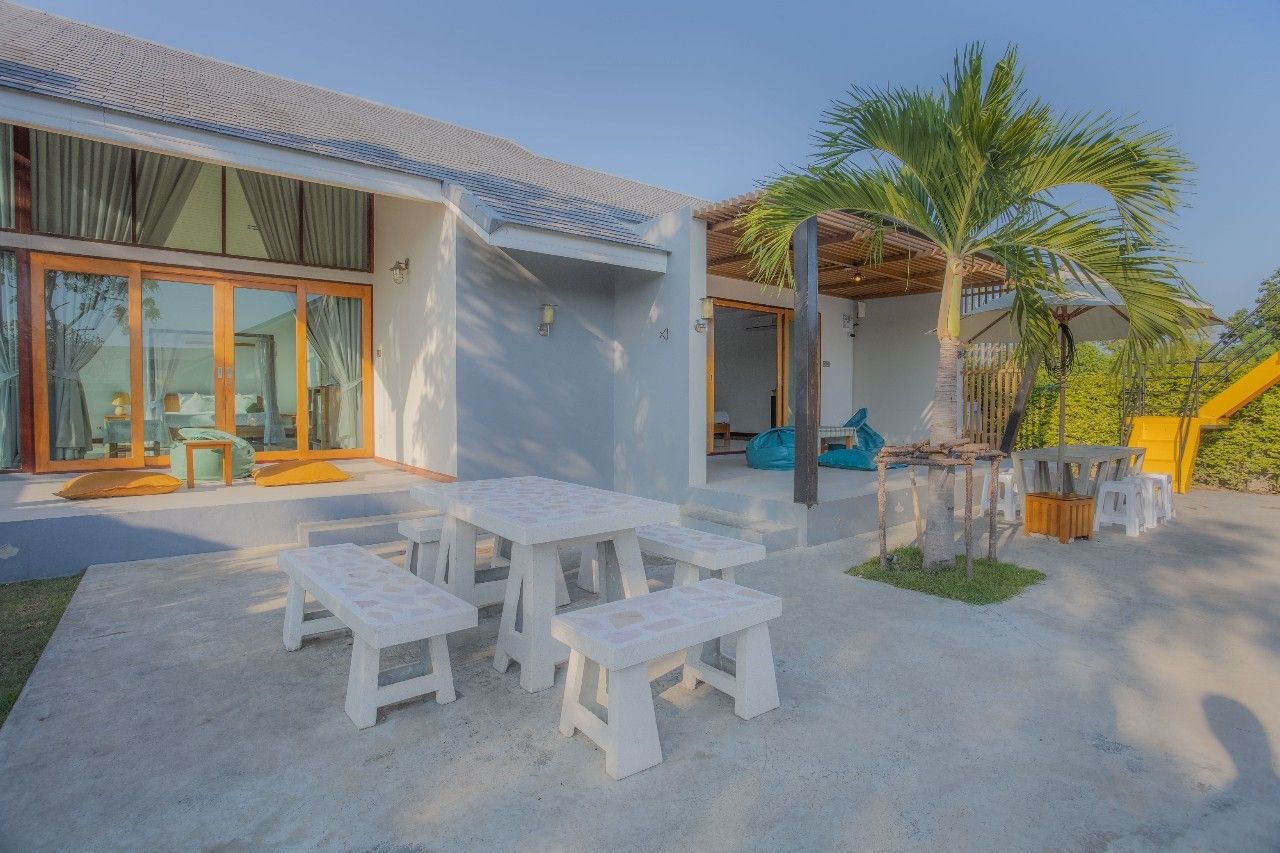 Outdoor dining area at Proud II Pool Villa, Hua Hin. Table and benches on the patio near the villa.