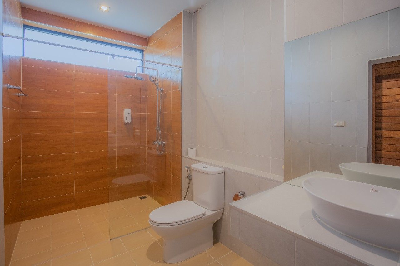 Modern bathroom with walk-in shower and vessel sink at Proud II Pool Villa, Hua Hin. Clean and bright design.