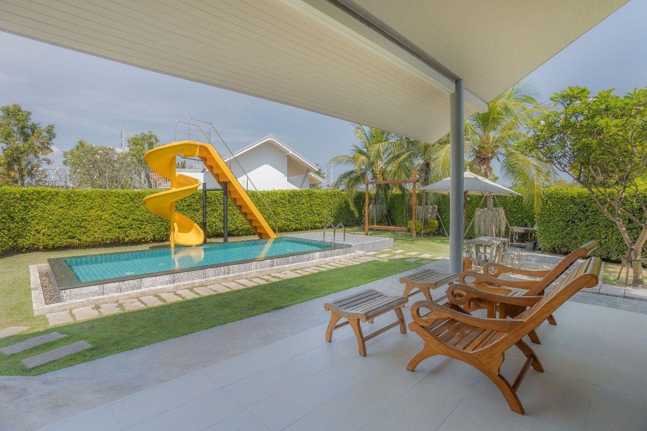 Fun pool with waterslide at Proud III Pool Villa, Hua Hin. Relax on the patio and enjoy the sun.