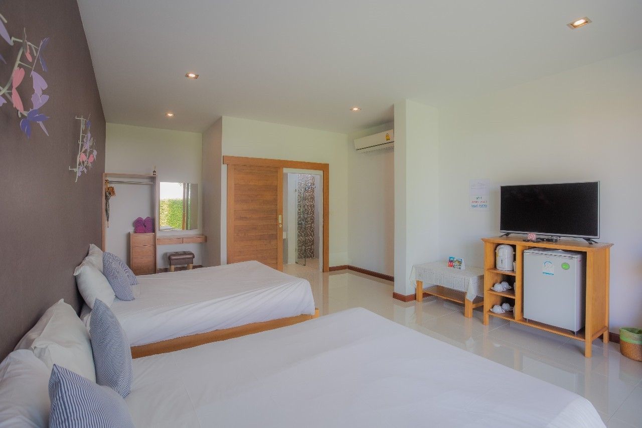 Bright bedroom with twin beds and TV in Proud III Pool Villa, Hua Hin, Thailand.