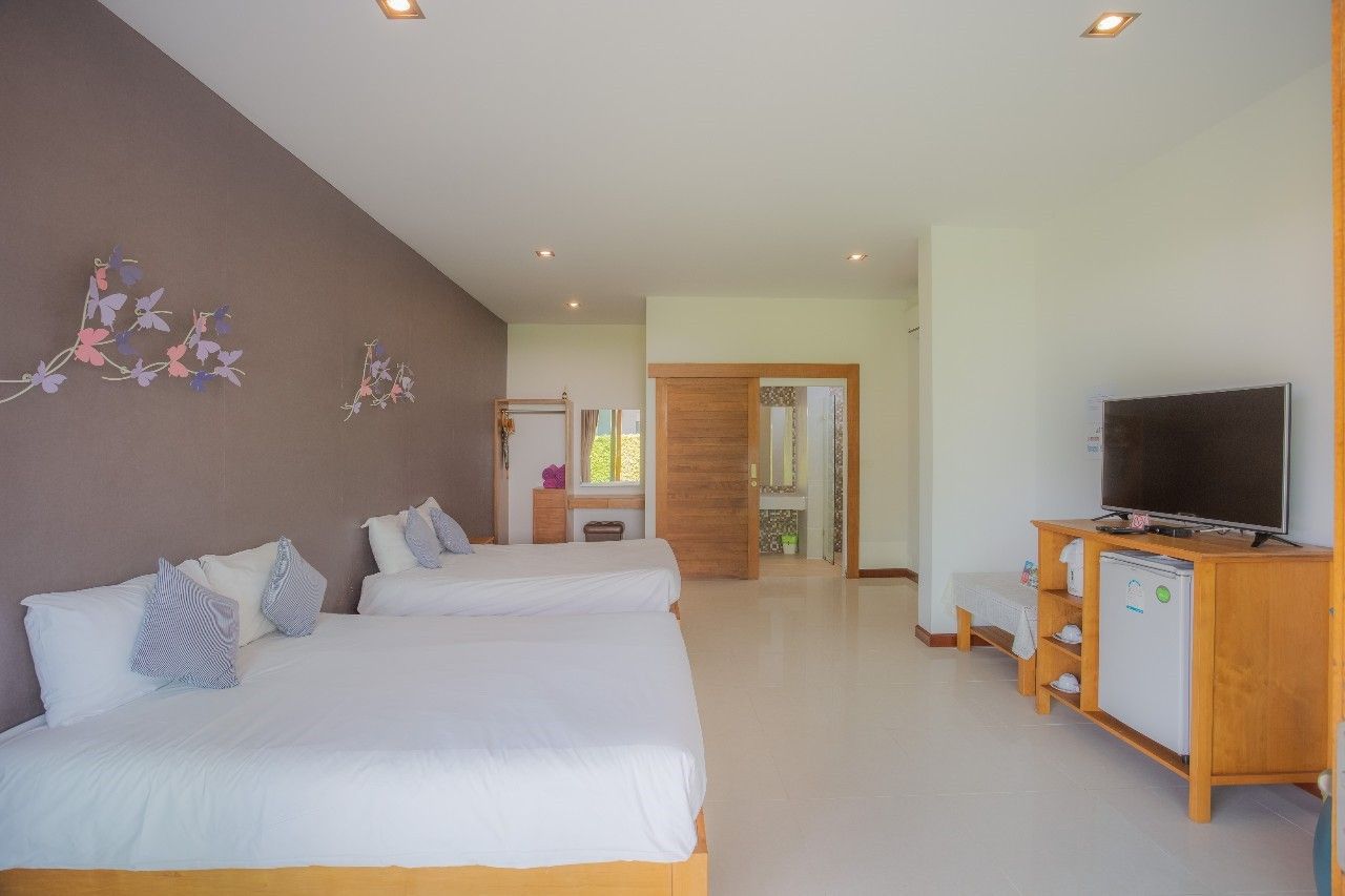 Bright bedroom with twin beds and ensuite bathroom at Proud III Pool Villa, Hua Hin, Thailand.