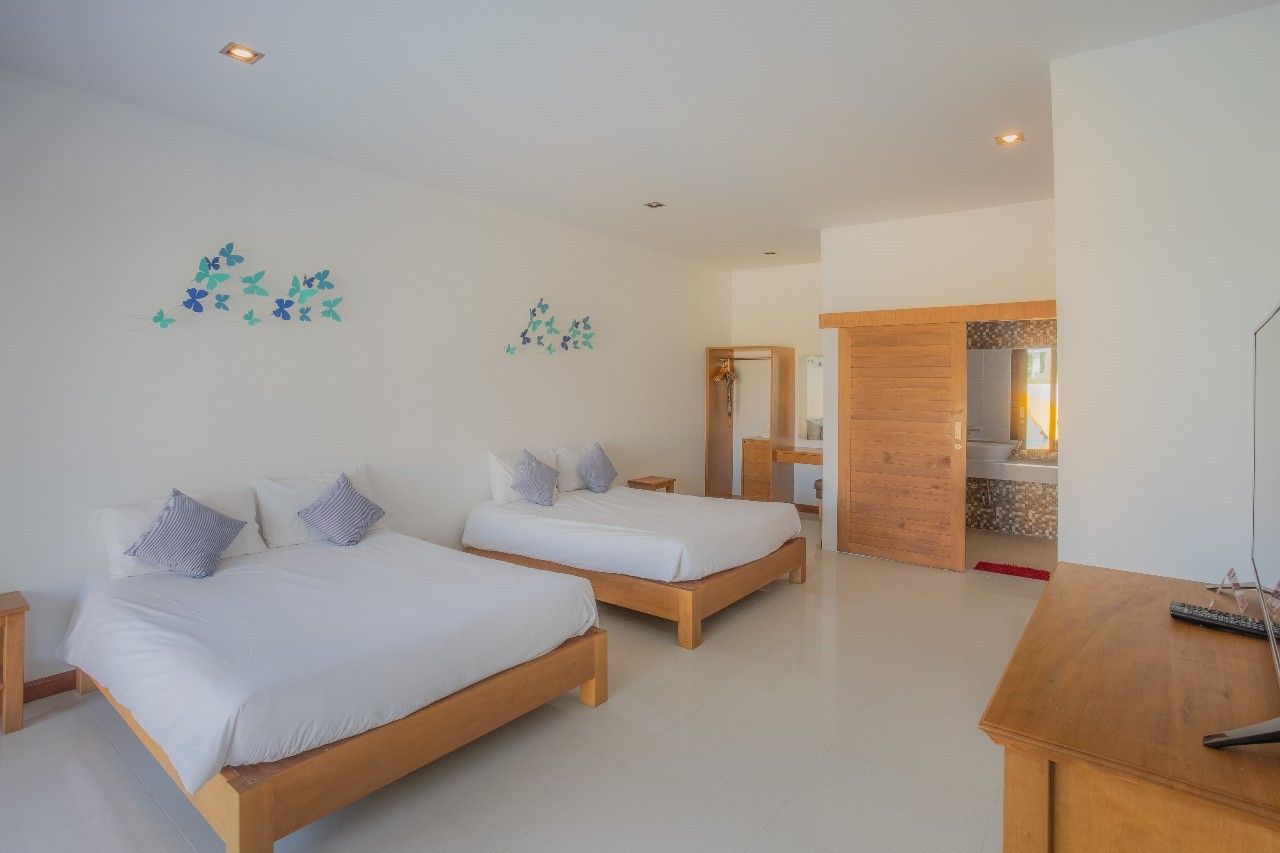 Bright bedroom with twin beds and ensuite bathroom at Proud IV Pool Villa, Hua Hin, Thailand.