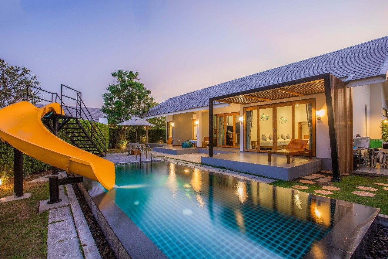 Private pool with waterslide at Proud IV Pool Villa, Hua Hin. Enjoy family fun in this luxury villa rental.