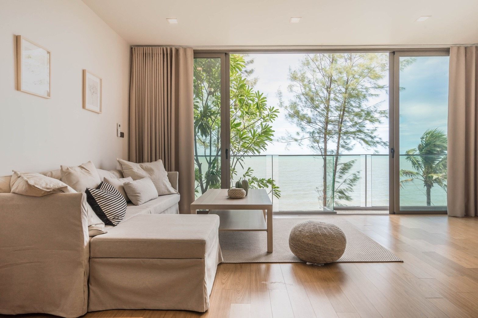 Living room with ocean view at Sand Beachfront Exclusive Villa, ติดทะเลพัทยาเหนือ บางละมุง. Sofa, coffee table, and floor-to-