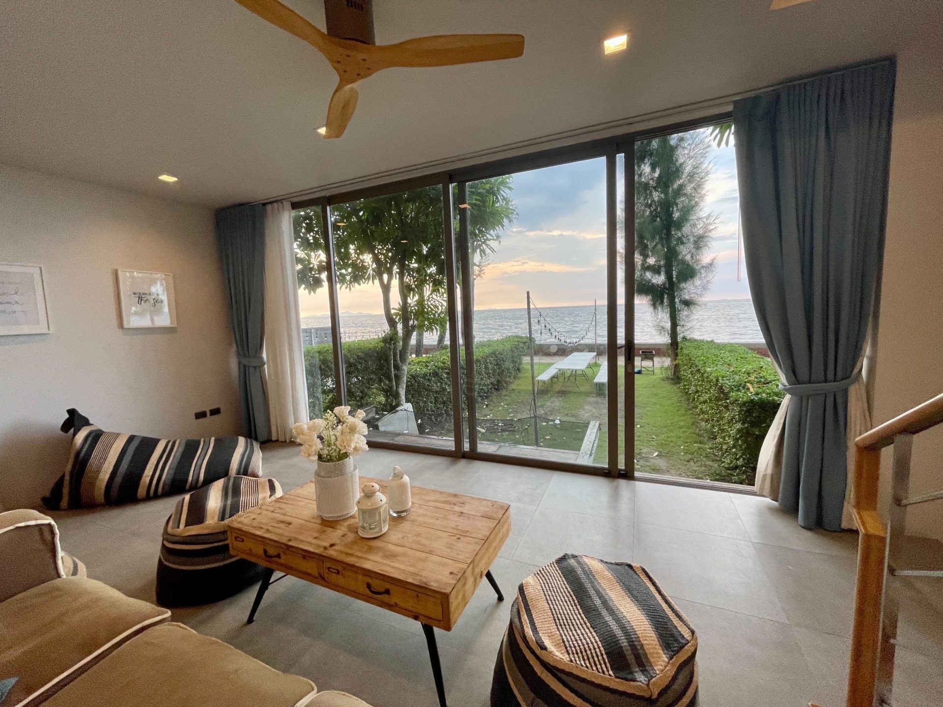 Living room with ocean view at Sand Beachfront Pool Villa III, North Pattaya. Relax in style with sea breezes.