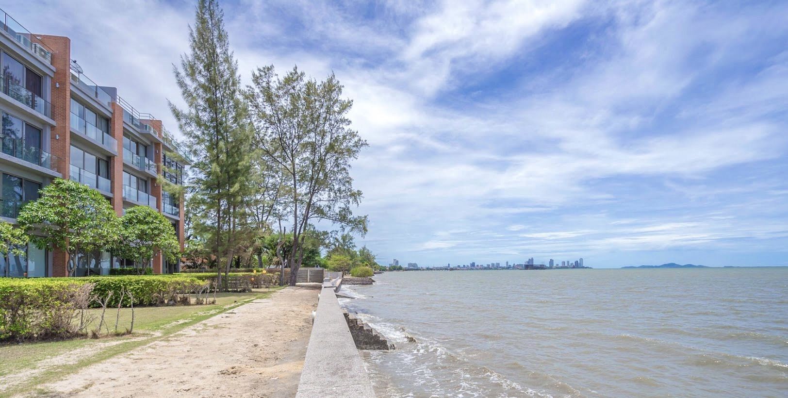 Sand Beachfront Villa IV exterior view in North Pattaya, Thailand, showing the building's proximity to the beach and ocean.