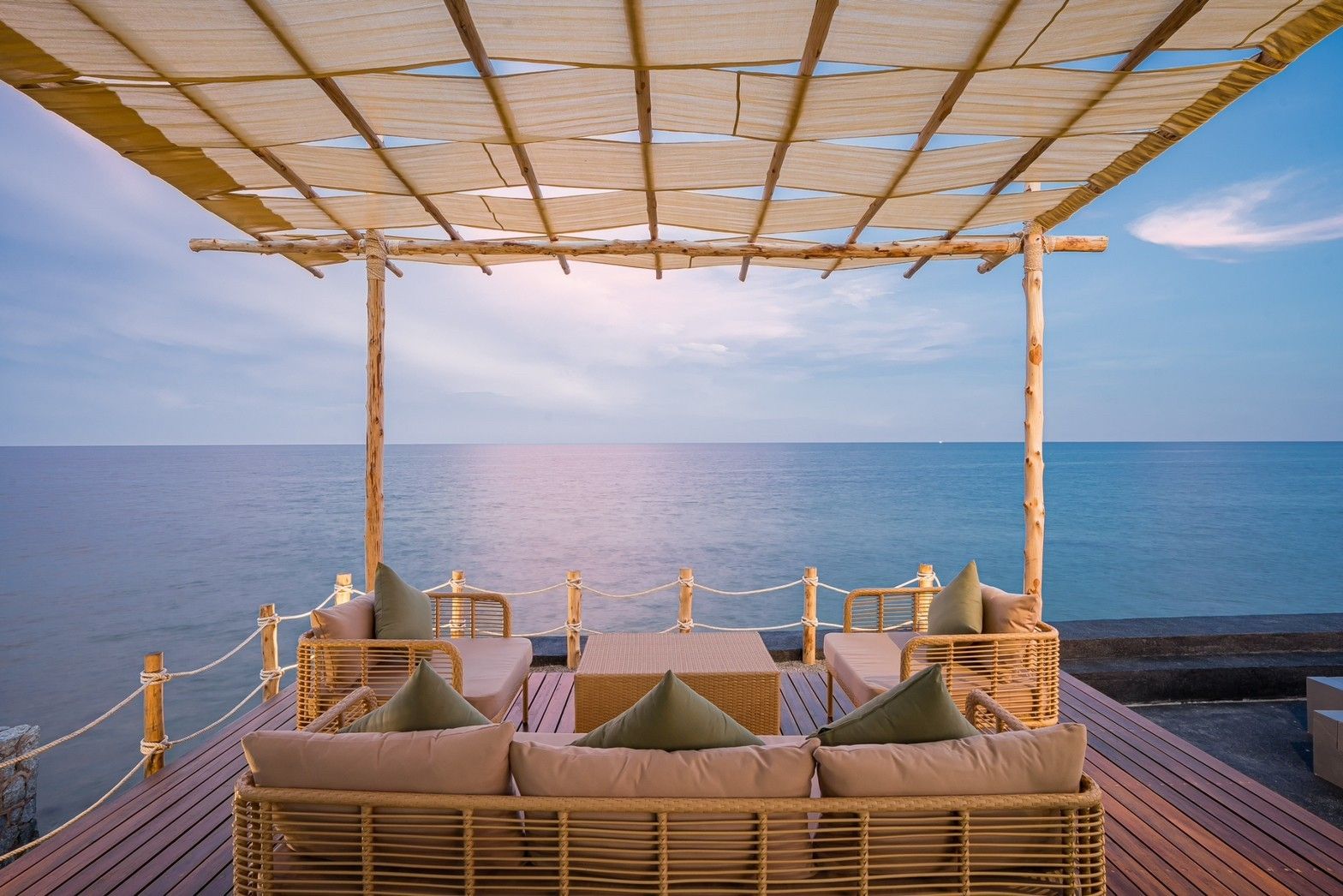 Oceanfront lounge area at Sea Fan IV Beachfront Pool Villa near Huahin airport. Relax on the wicker furniture and enjoy the s