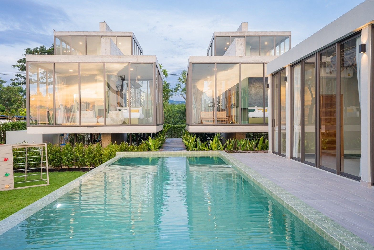 Sea Fan IV beachfront pool villa near Huahin airport. Modern villas with glass walls overlook the turquoise swimming pool.