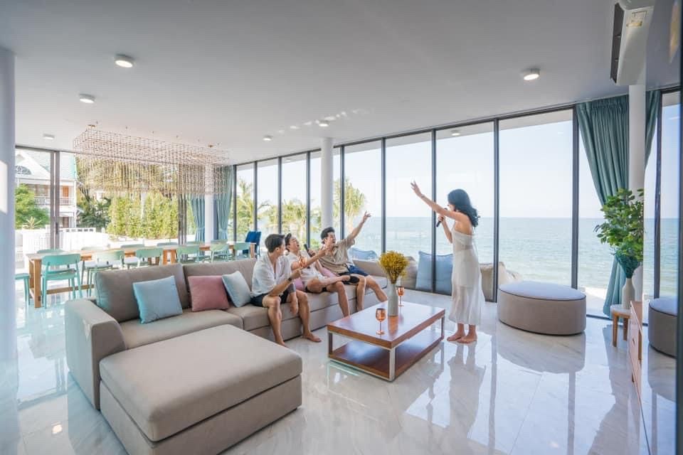 Guests enjoy karaoke in the living room with ocean views at Sea Lion VIII Pool Villa, Cha Am, Phetchaburi.
