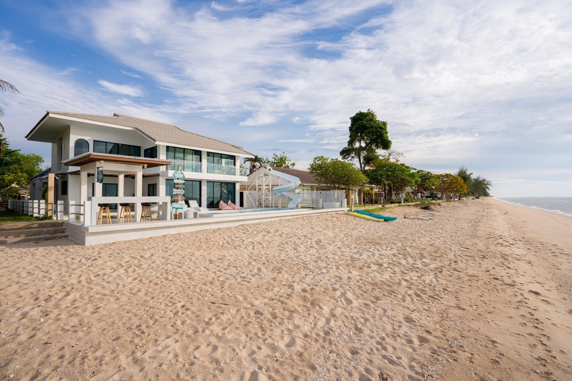 Beachfront facade of Sea Time V Pool Villa in Cha-Am, Thailand. View of the villa from the sandy beach.