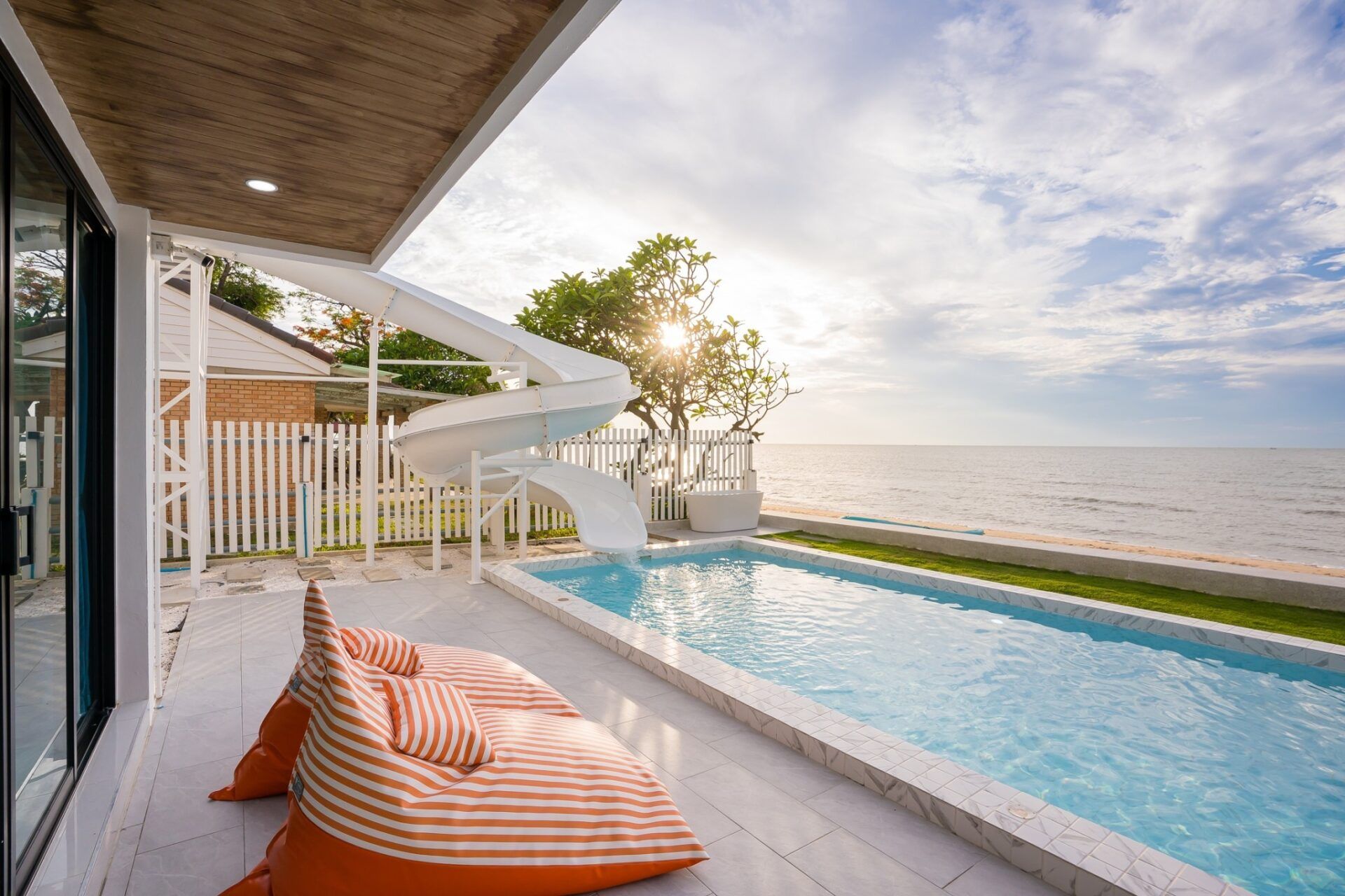Sea Time V Pool Villa in Cha-Am features a private pool with a water slide and ocean views. Relax on the striped beanbag.