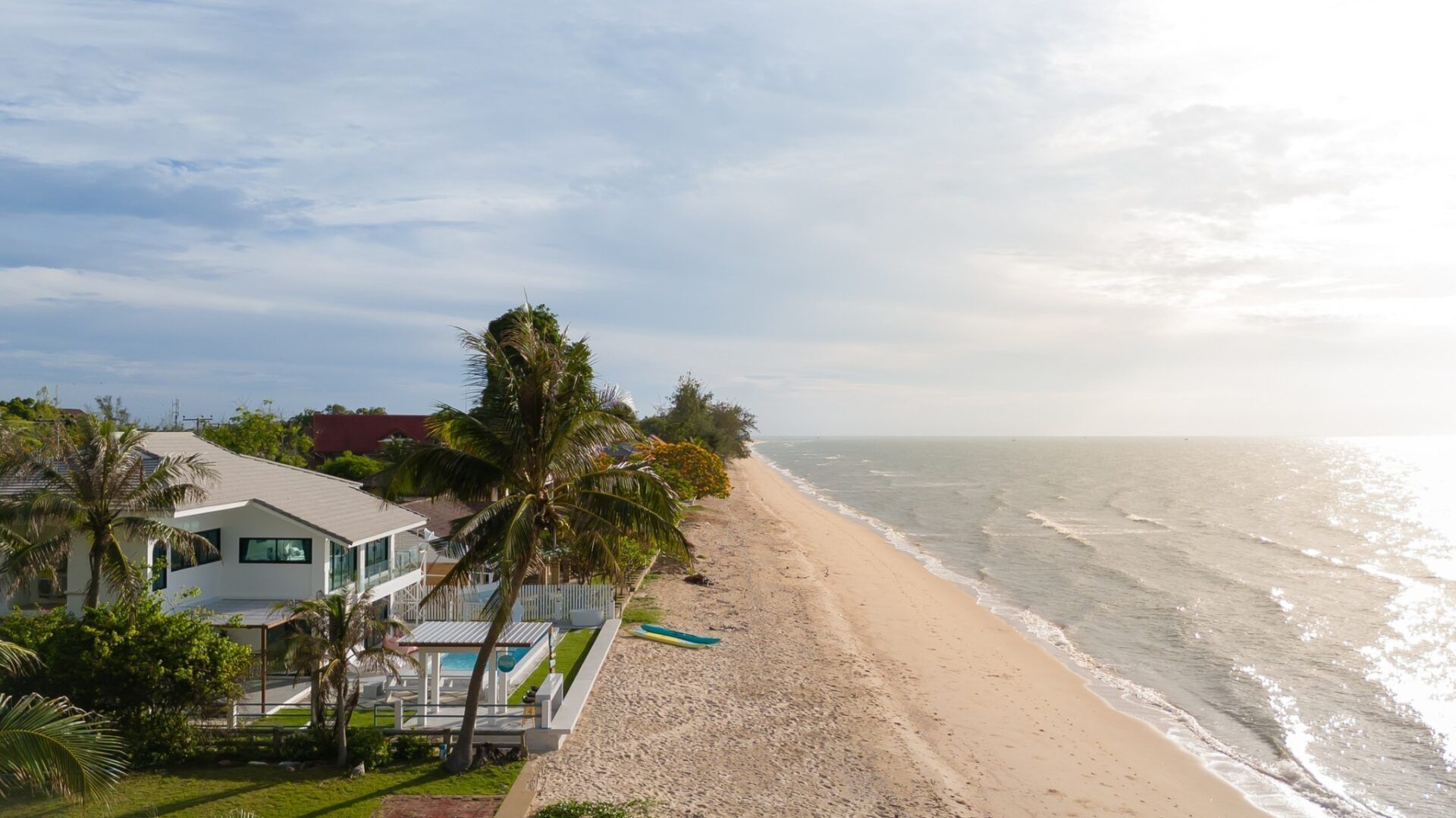 Aerial view of Sea Time V Pool Villa in Cha-Am, Thailand, showcasing its beachfront location and beautiful architecture.
