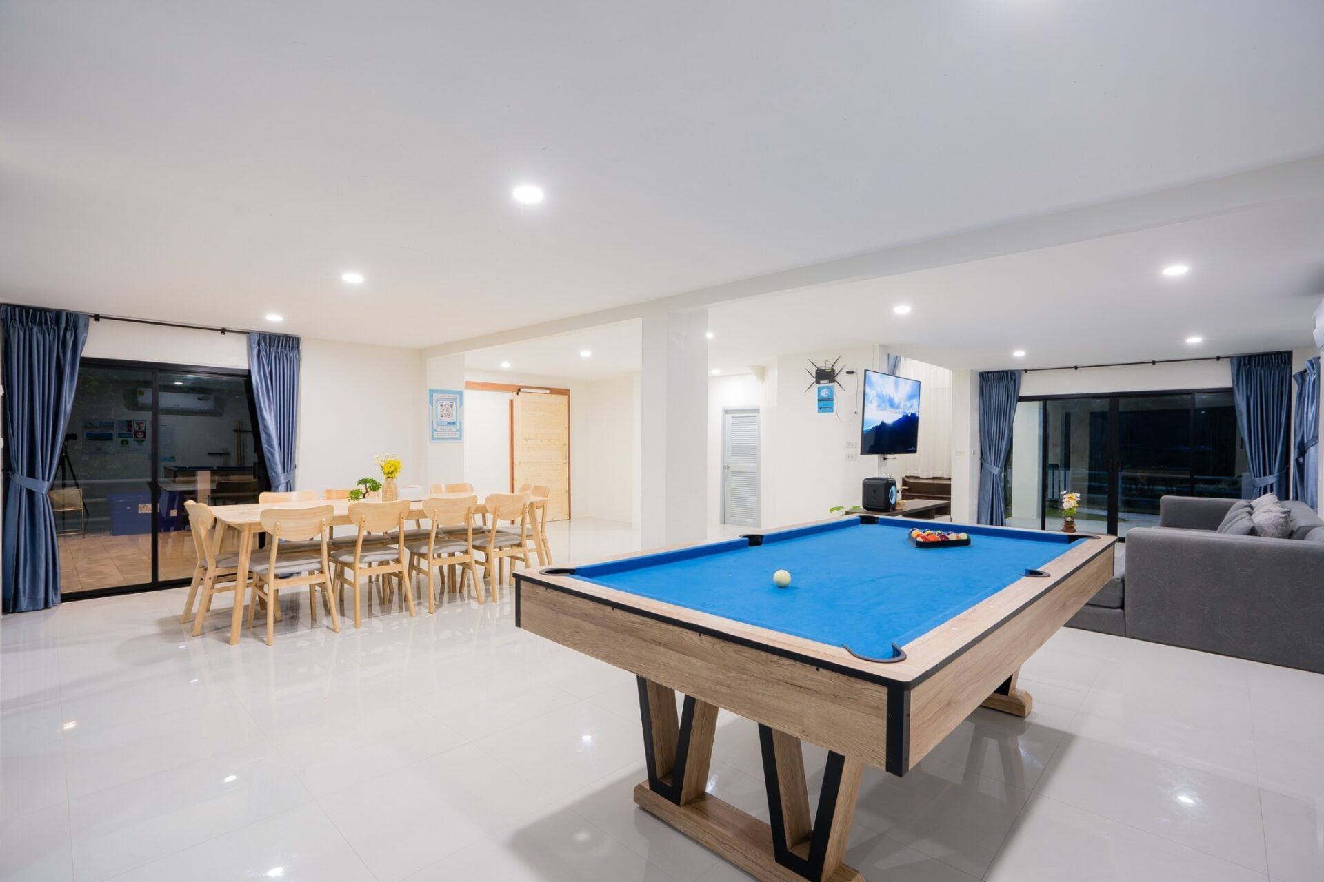 Bright, open living space with pool table and dining area at Sea Time V Pool Villa, Cha-Am.