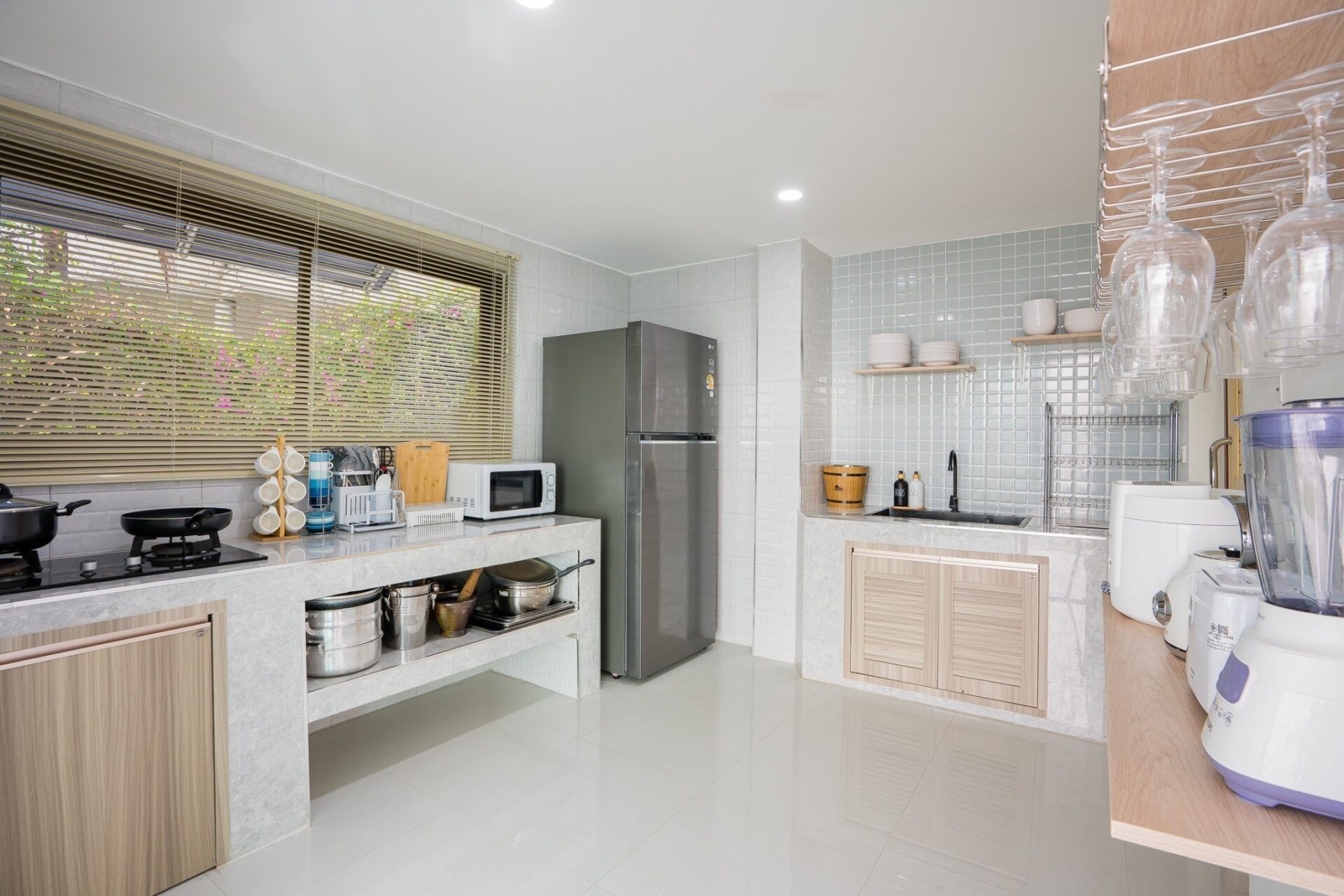 Bright modern kitchen with appliances at Sea Time V Pool Villa, Cha-Am, Thailand.
