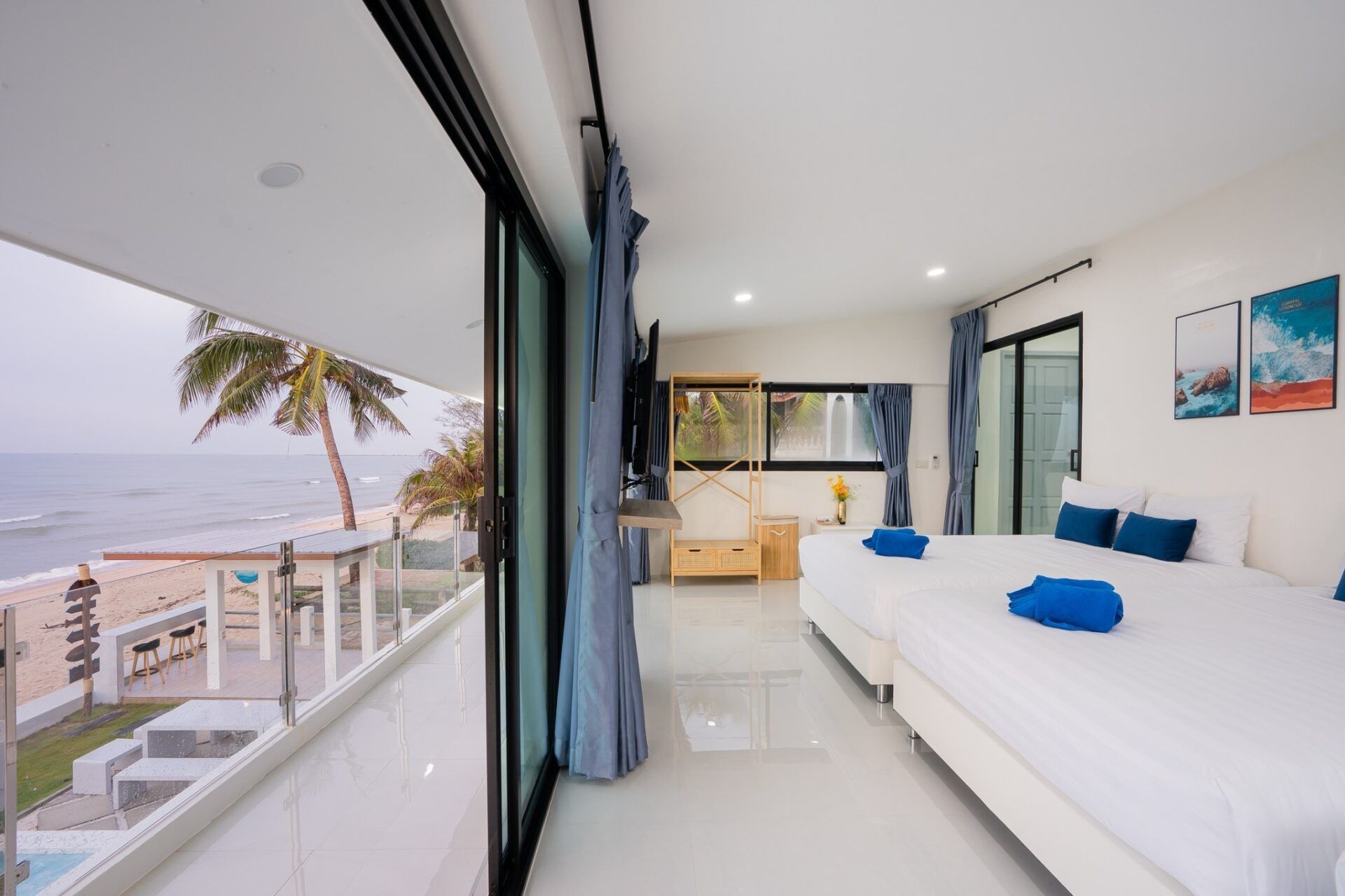 Bright bedroom with balcony overlooking the beach at Sea Time V Pool Villa, Cha-Am, Thailand.
