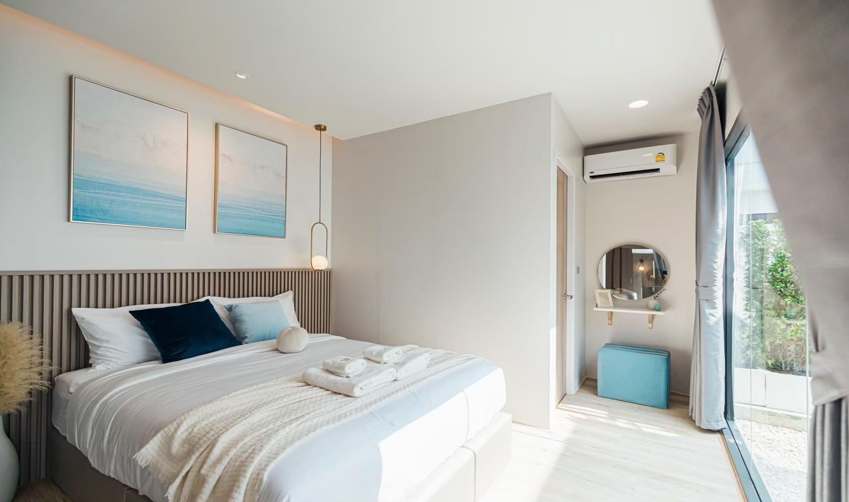 Bright bedroom at SHORE SEASON V Pool Villa, Banglamung. King bed, blue accents, and modern decor create a relaxing space.