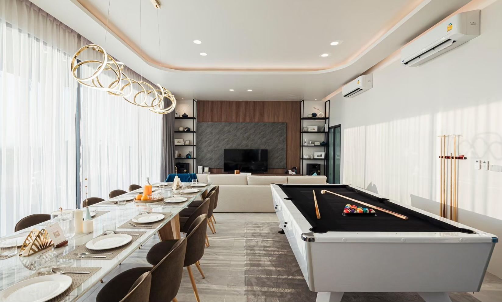 Billiard table and dining area at SHORE SEASON V Pool Villa, Banglamung, Pattaya. Open floor plan with modern lighting.
