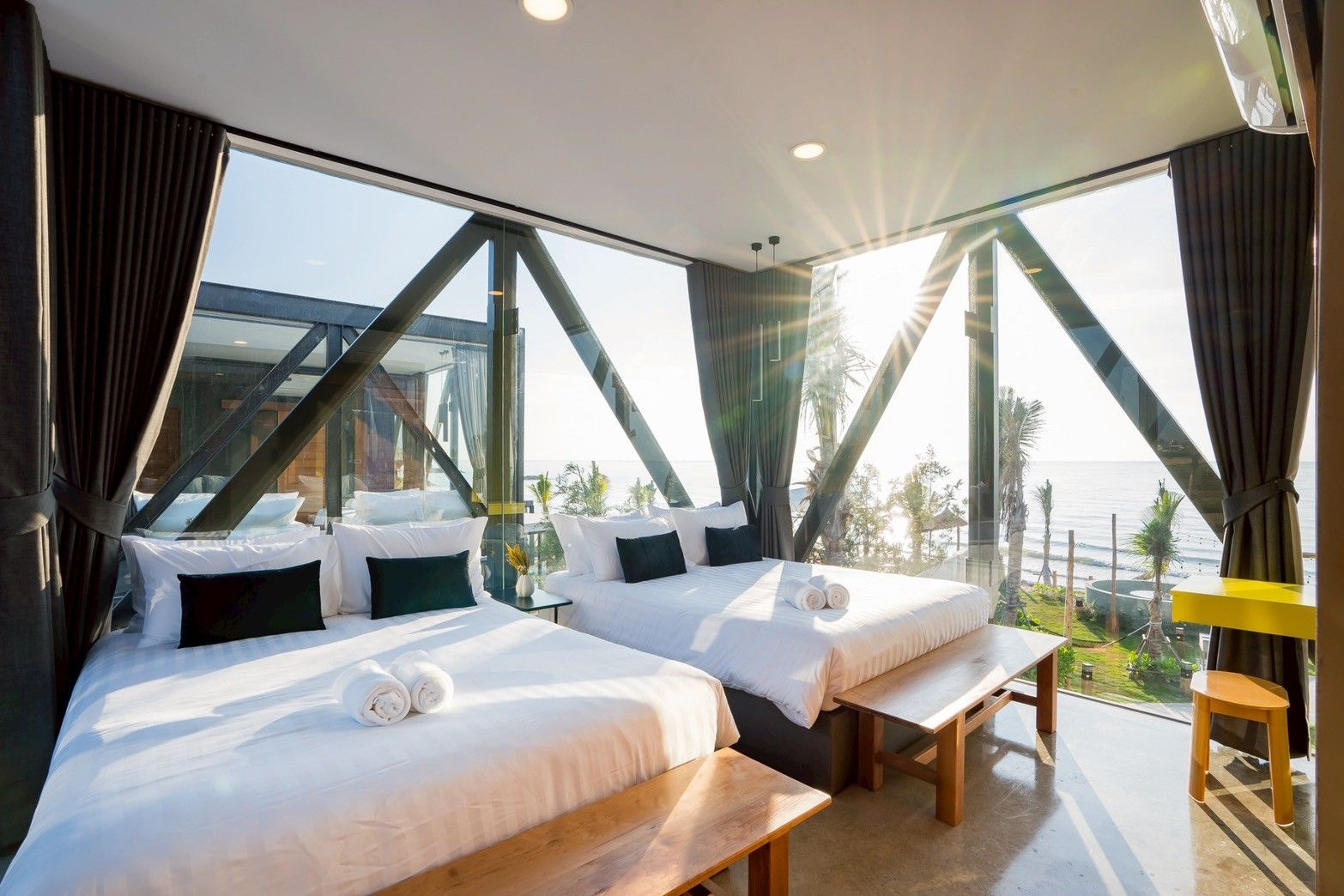 Bright bedroom with twin beds and ocean view at Spirit V Pool Villa, หาดปึกเตียน-ชะอำ. Modern design with floor-to-ceiling wi