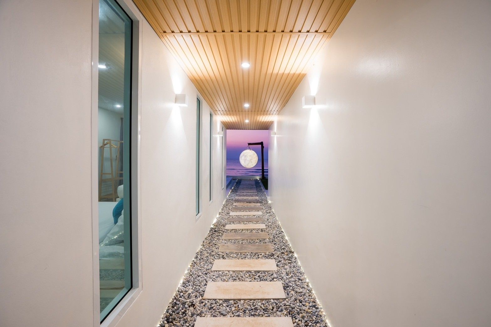Unique stone pathway with moon sculpture at Sun Sea V Pool Villa, ติดทะเล หาดบางเกตุ ชะอำ. View of the ocean.