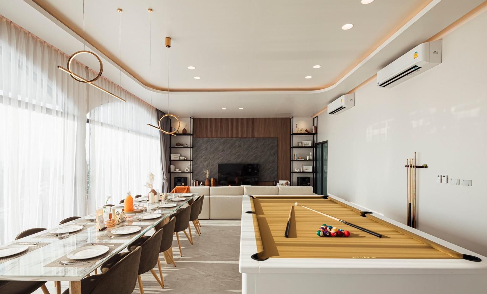 Billiard table, dining table, and living room at Sun Season V Pool Villa, Banglamung, Pattaya. Open floor plan.