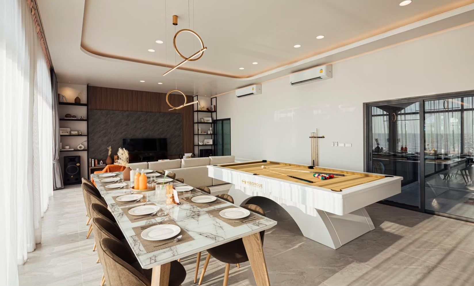 Open living space with dining table and billiard table at SUN SEASON V Pool Villa, Banglamung, Pattaya.