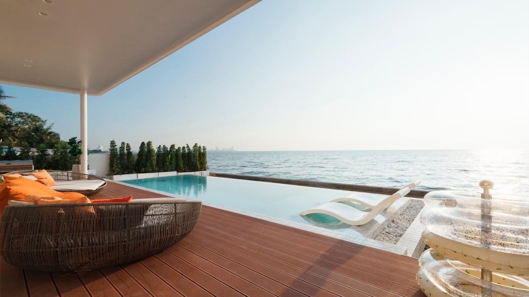 Ocean view from the infinity pool at Sun Season V Pool Villa, Banglamung Pattaya. Lounge chairs and seating area on the pool 