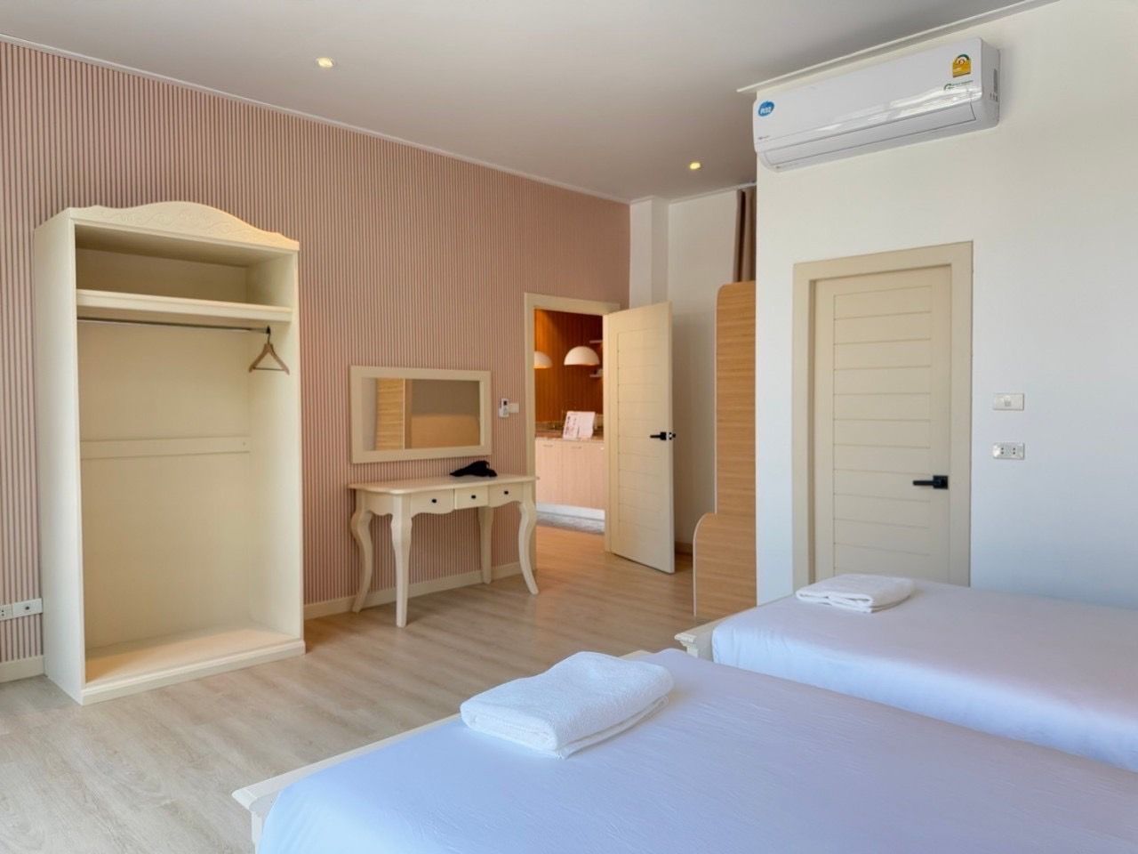 Bedroom with twin beds, wardrobe, and vanity at The Valley Khao Yai II pool villa, Khao Yai, Thailand.