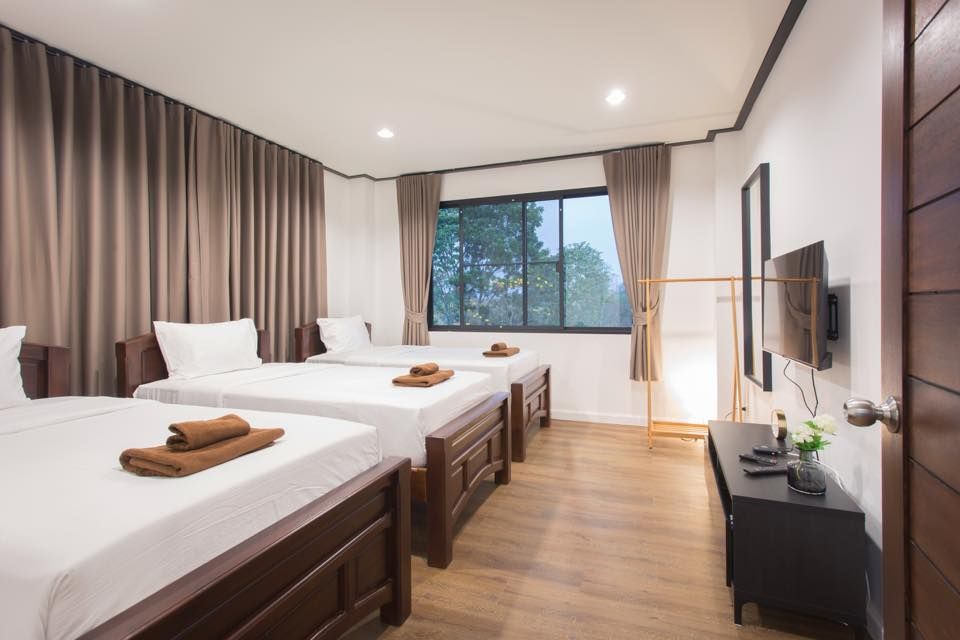 The Valley Khaoyai V Villa bedroom with three single beds and TV in Khao Yai, Thailand.