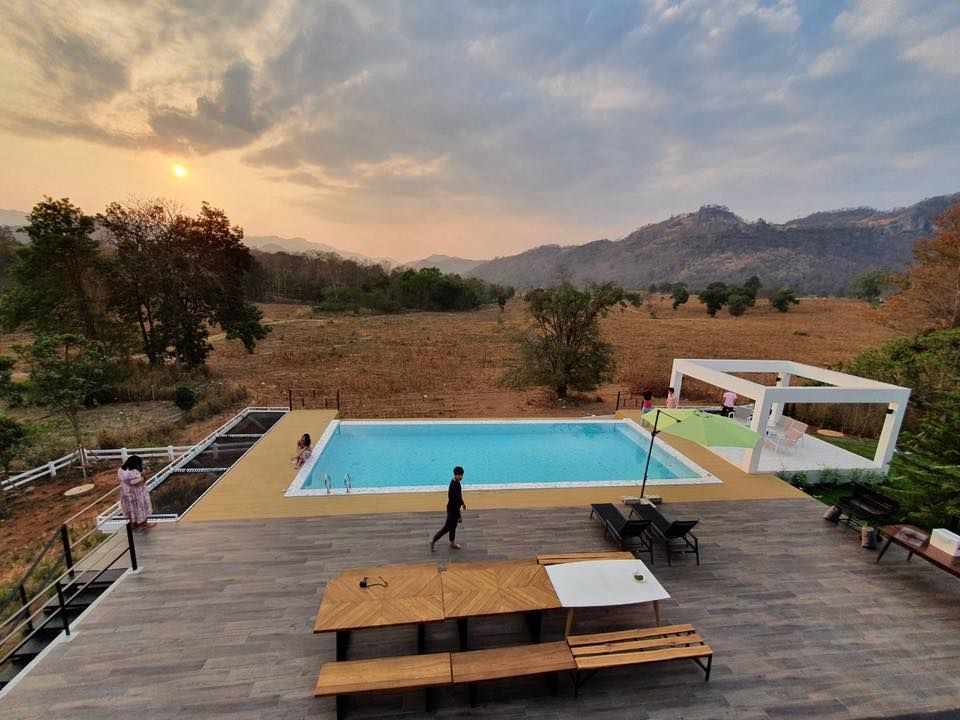 Stunning sunset view from the pool deck at The Valley Khaoyai V Villa, Khao Yai, Thailand.