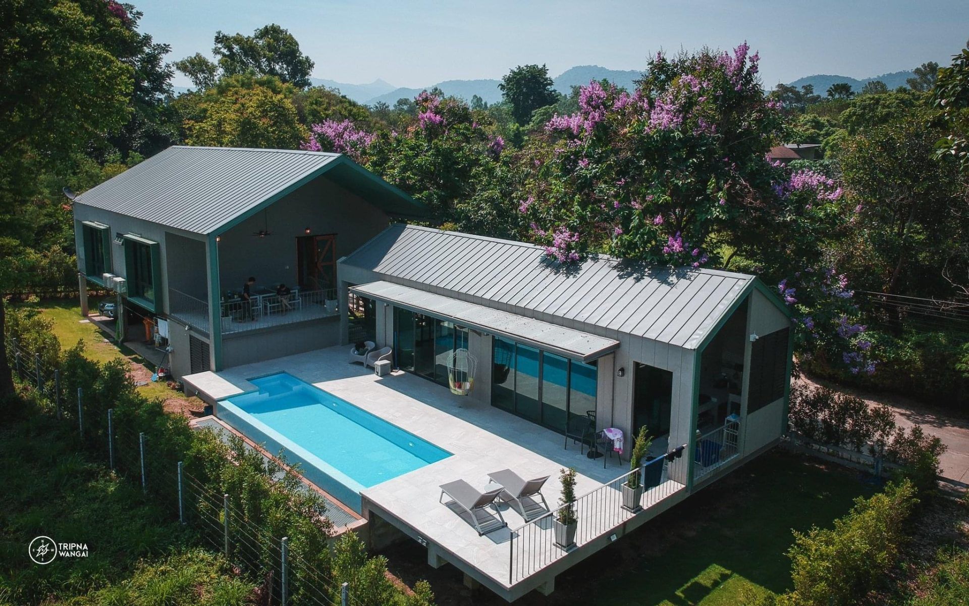 Aerial view of The Valley Khaoyai VI Villa showing the pool and modern architecture. Surrounded by lush greenery in หมูสี เขา