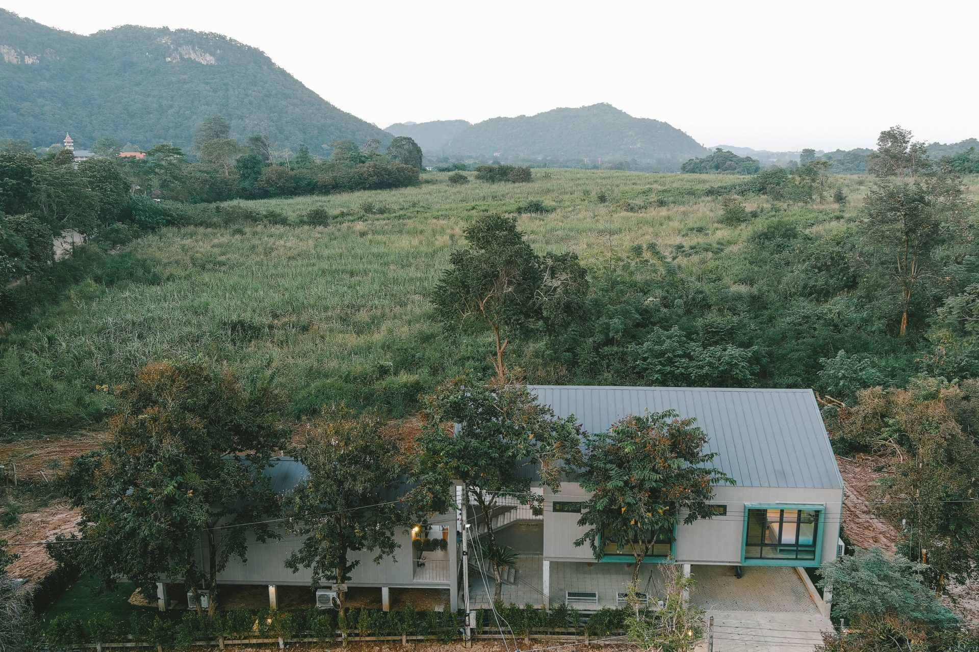 Aerial view of The Valley Khaoyai VI Villa, หมูสี เขาใหญ่, surrounded by lush greenery and mountains.