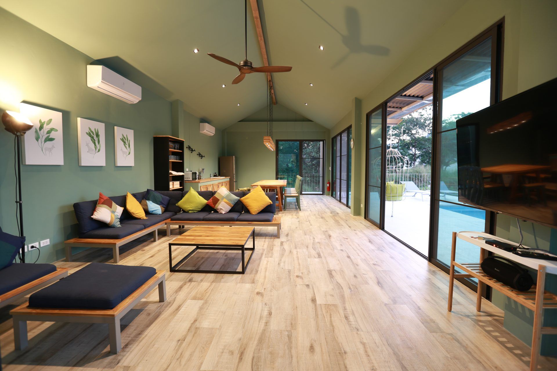 Spacious living area at The Valley Khaoyai VI Villa, หมูสี เขาใหญ่. Open floor plan with sofas, dining table, and pool view.