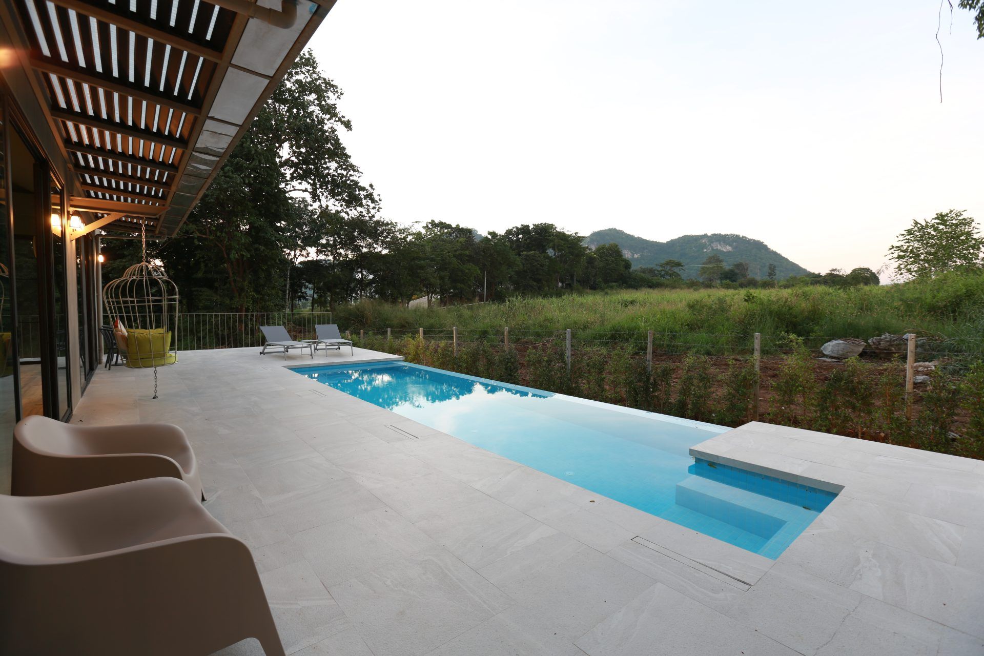 Lap pool and lounge chairs at The Valley Khaoyai VI Villa, หมูสี เขาใหญ่. Enjoy the pool with a view.