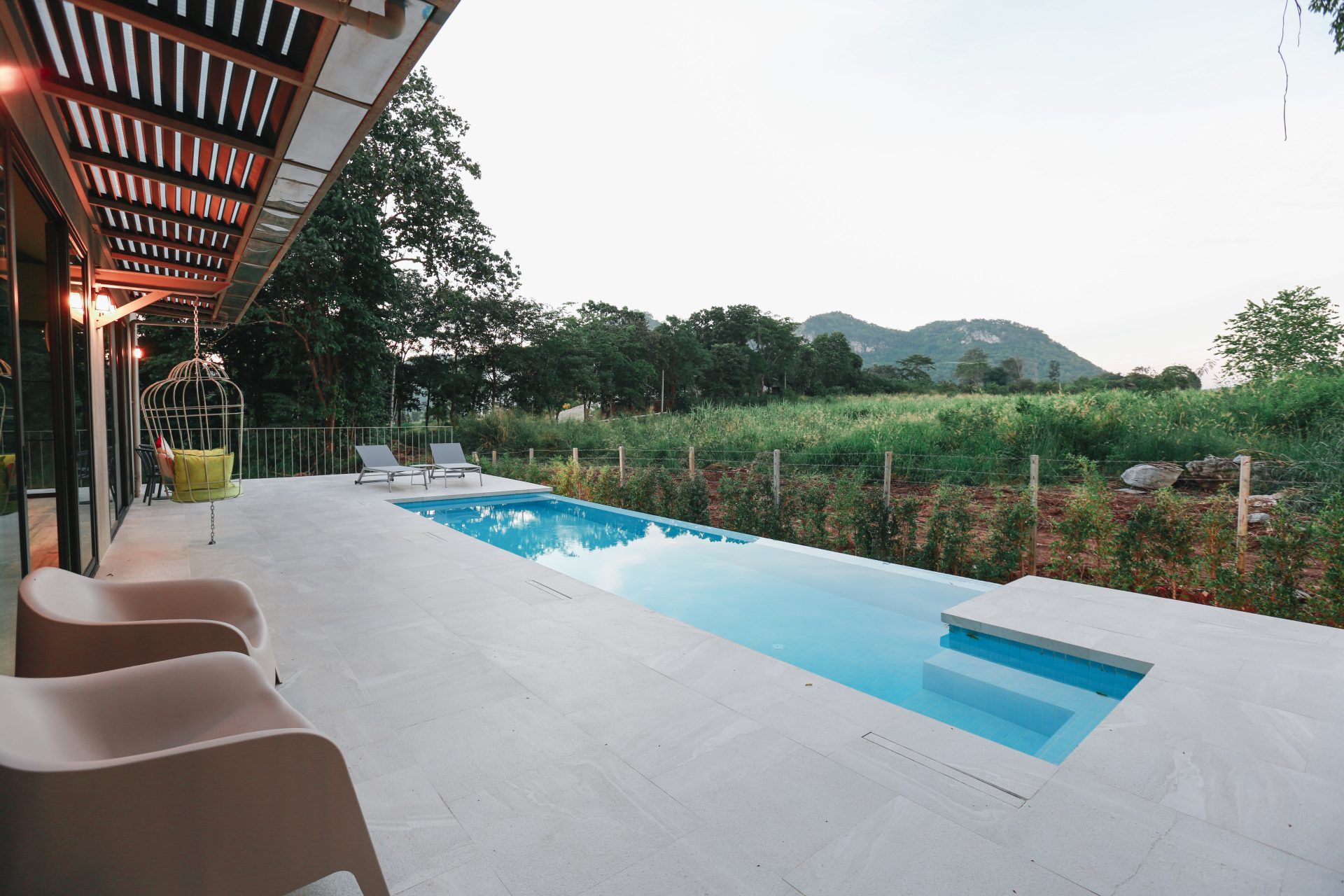 Lap pool and lounge chairs at The Valley Khaoyai VI Villa, หมูสี เขาใหญ่. Relaxing pool view.