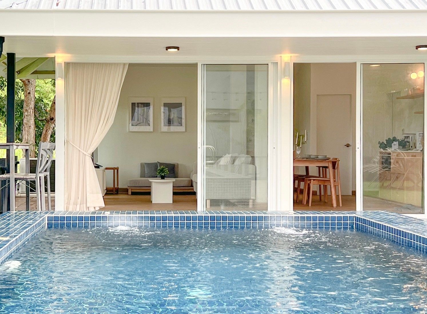 View from the pool into the living and dining areas at The Valley Khaoyai VIII Villa, หมูสี เขาใหญ่.