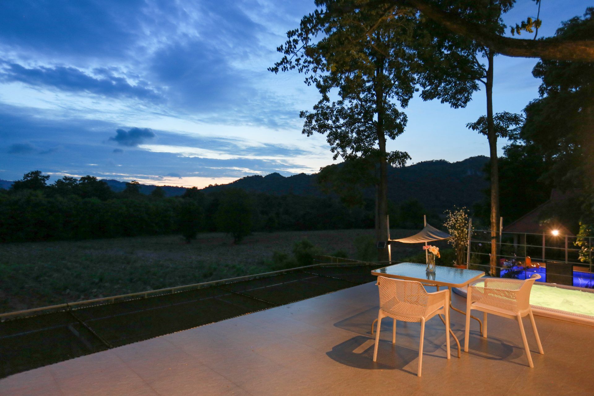Outdoor dining terrace at Tree House III Pool Villa, Khao Yai. Enjoy the mountain view at dusk.