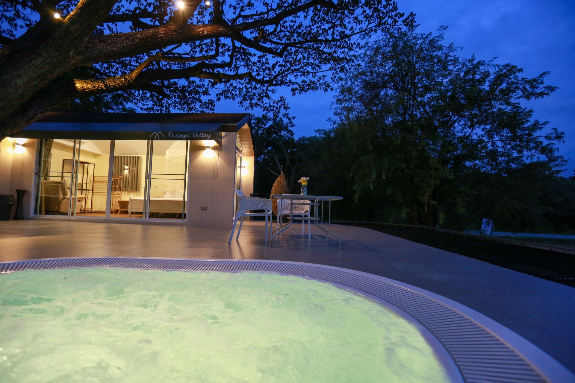 Night view of the jacuzzi at Tree House III Pool Villa, Khao Yai. Relax in the warm water under the stars.