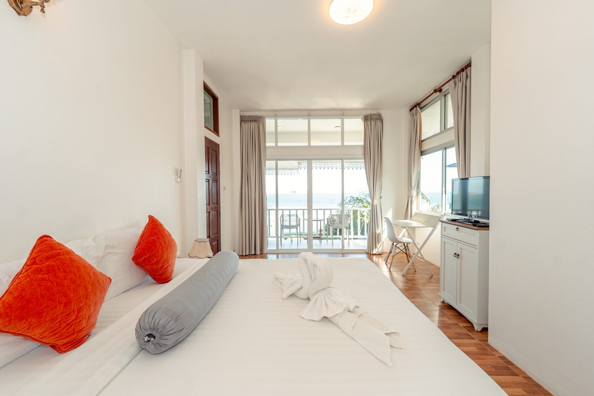 Bright bedroom with balcony and ocean view at Twenty-Six Pool Villa Hua-hin, หัวหิน 101 ประจวบฯ. Features king bed and TV.