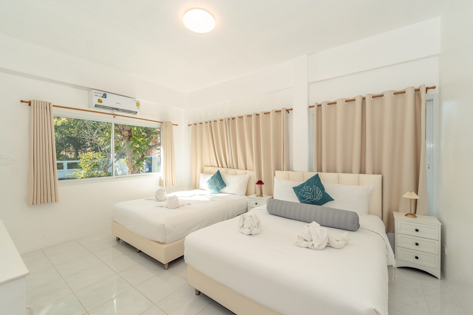 Bedroom with twin beds at Twenty-Six Pool Villa Hua Hin. View of the window and curtains.
