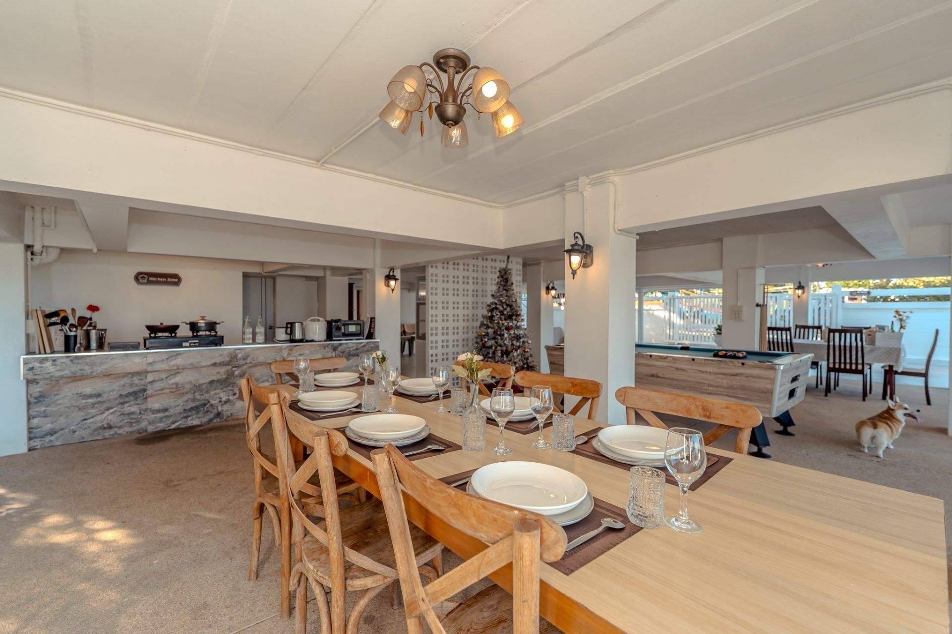 Dining table set for a meal at Twenty-Six Pool Villa Hua-hin, หัวหิน 101 ประจวบฯ. View of kitchen and pool table.