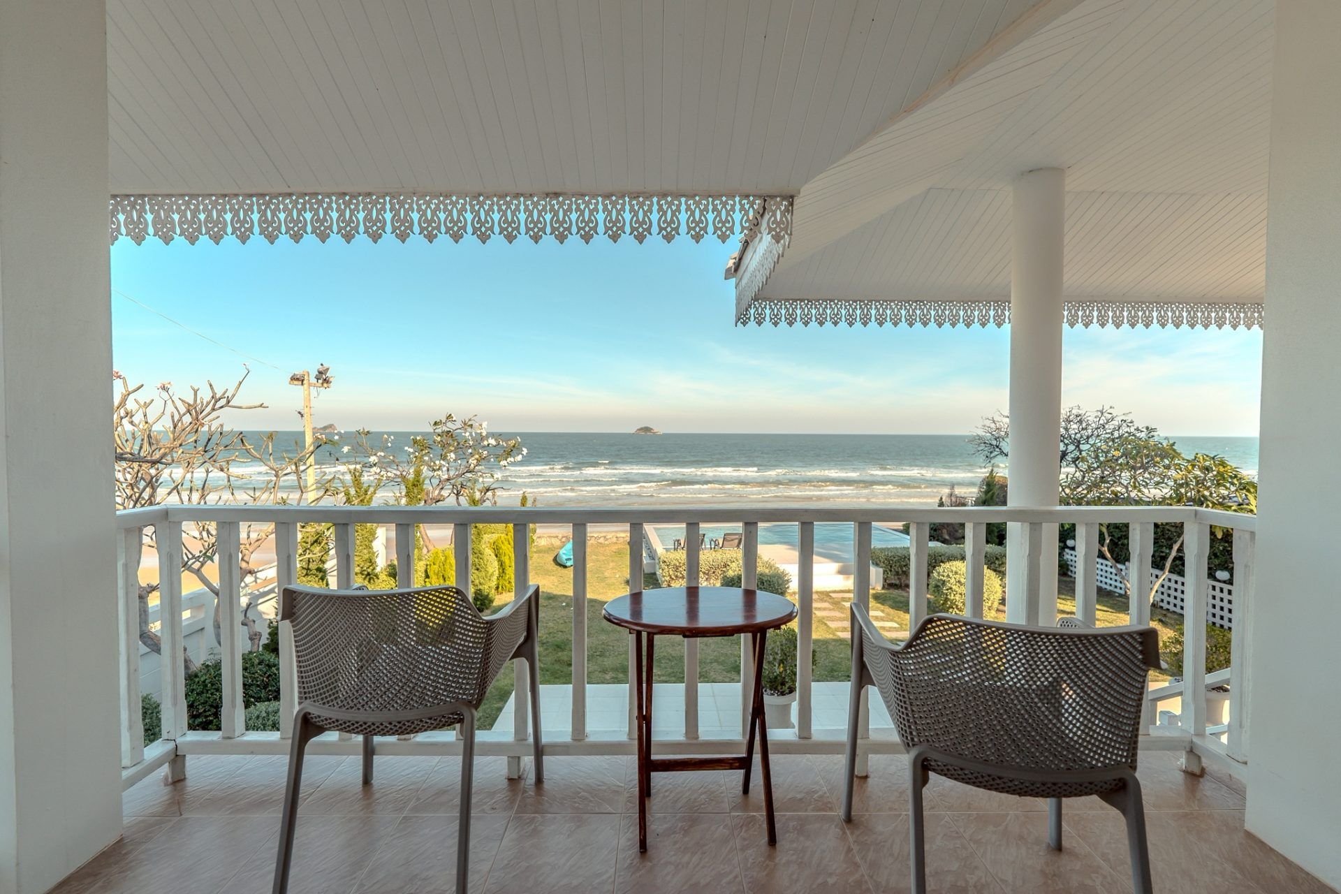 Ocean view balcony at Twenty-Six Pool Villa Hua-hin, หัวหิน 101 ประจวบฯ. Chairs and table on the balcony overlooking the sea.