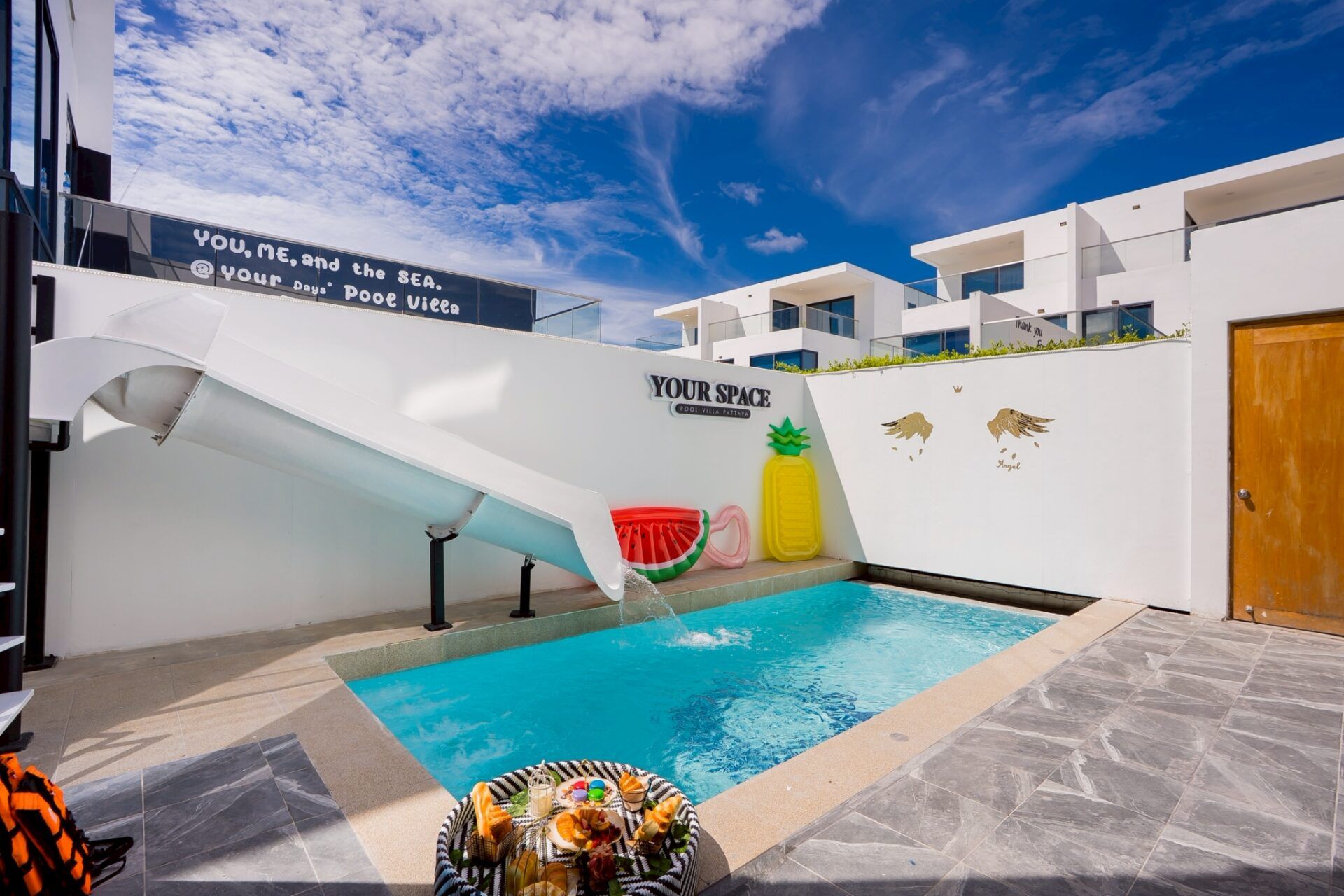 Pool courtyard with slide and pineapple float at Your Space IV