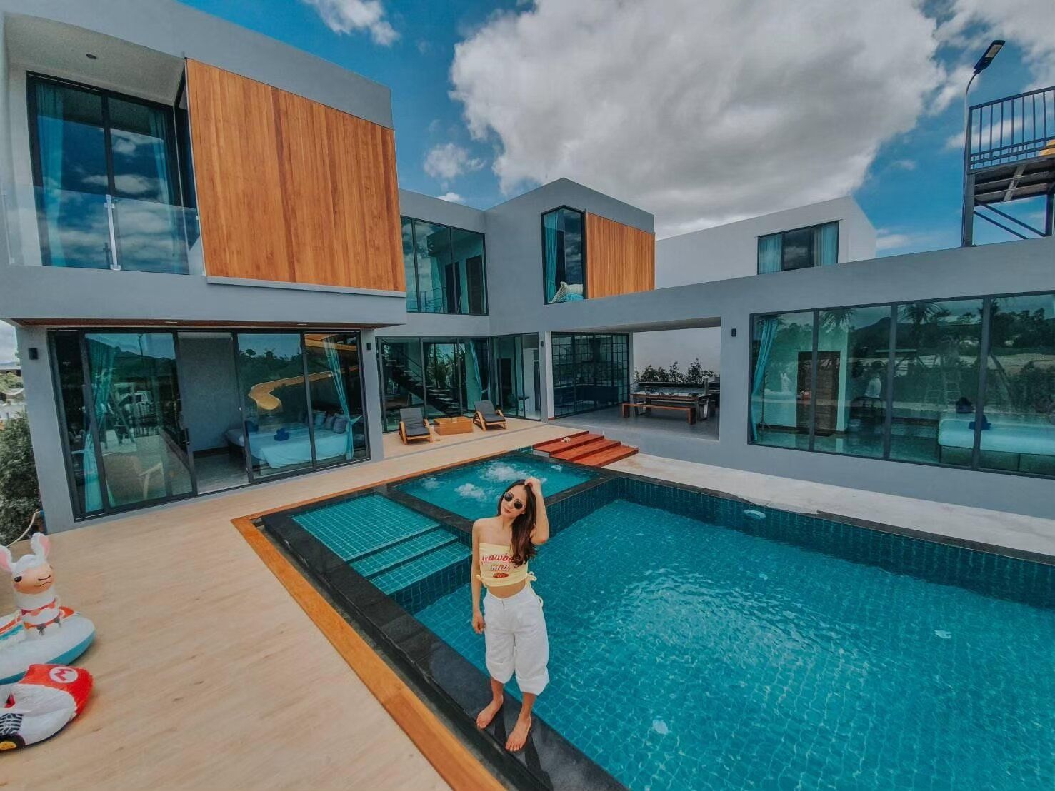 Exclusive Proud VII Villa in Hua Hin features a stunning multi-level pool with integrated jacuzzi and spacious pool deck.